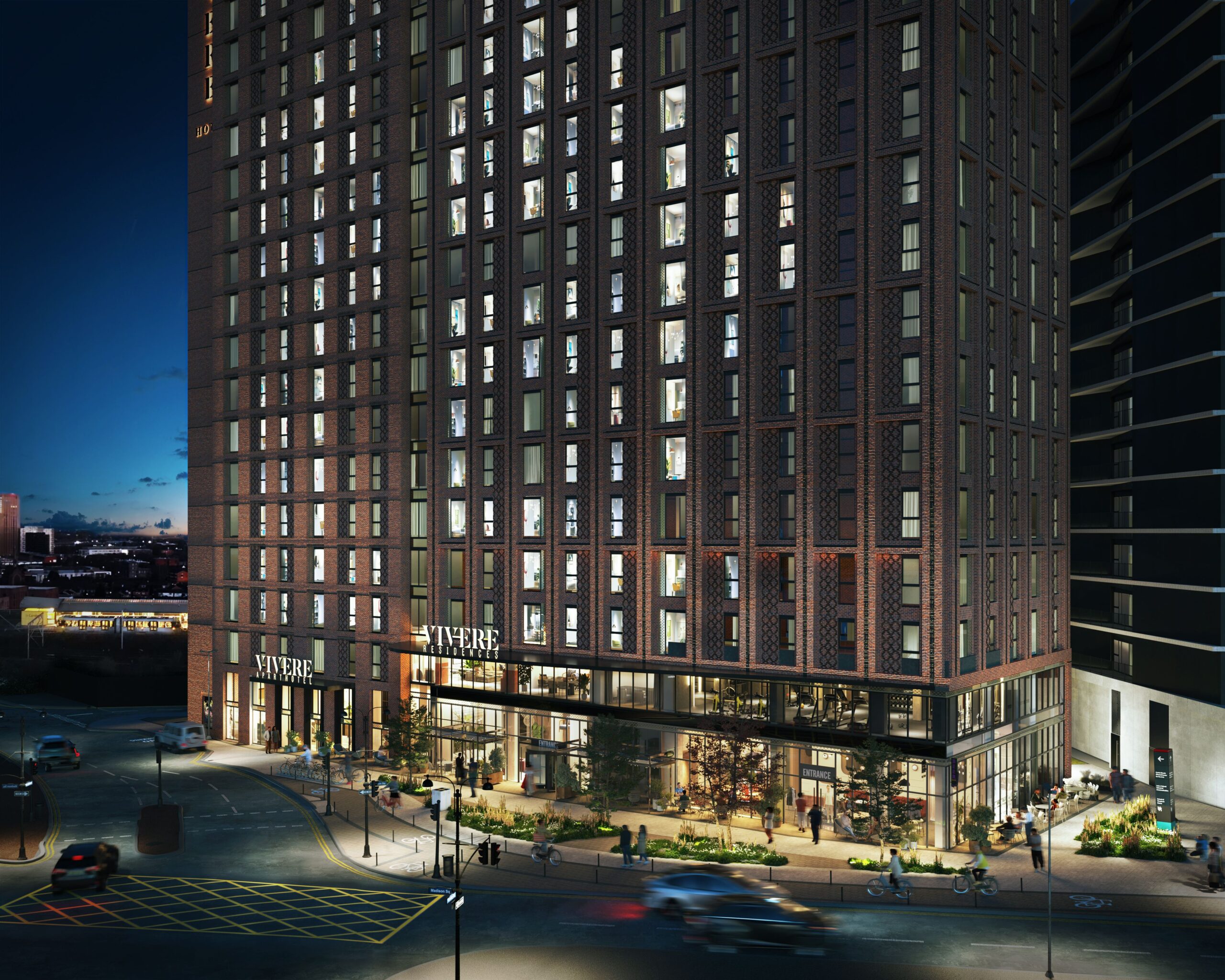 Night-time architectural CGI of Vivere Residences in Manchester showing the illuminated mixed-use development and active street frontage.
